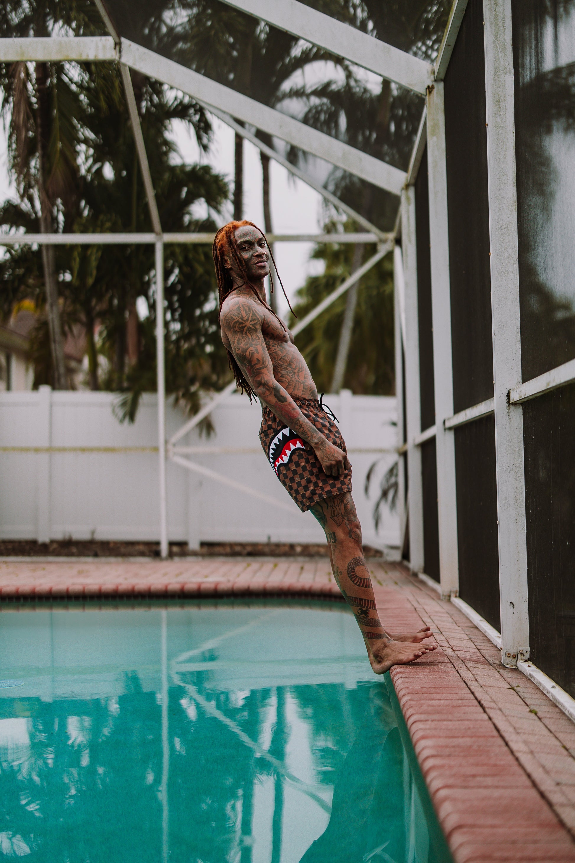 SPRAYGROUND® SWIM PEEKING CHARACTER CHECK SWIM SHORTS