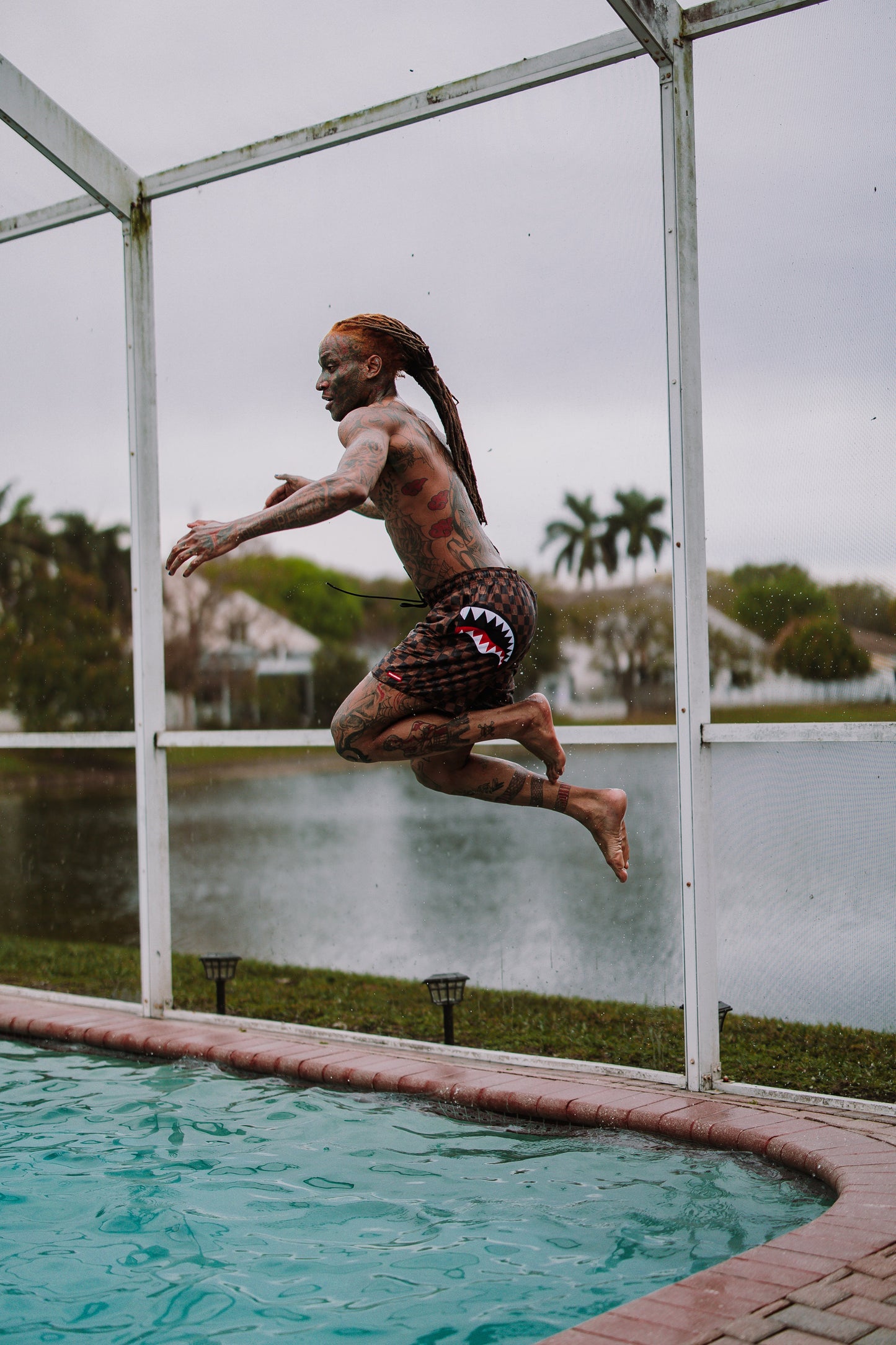 SPRAYGROUND® SWIM PEEKING CHARACTER CHECK SWIM SHORTS
