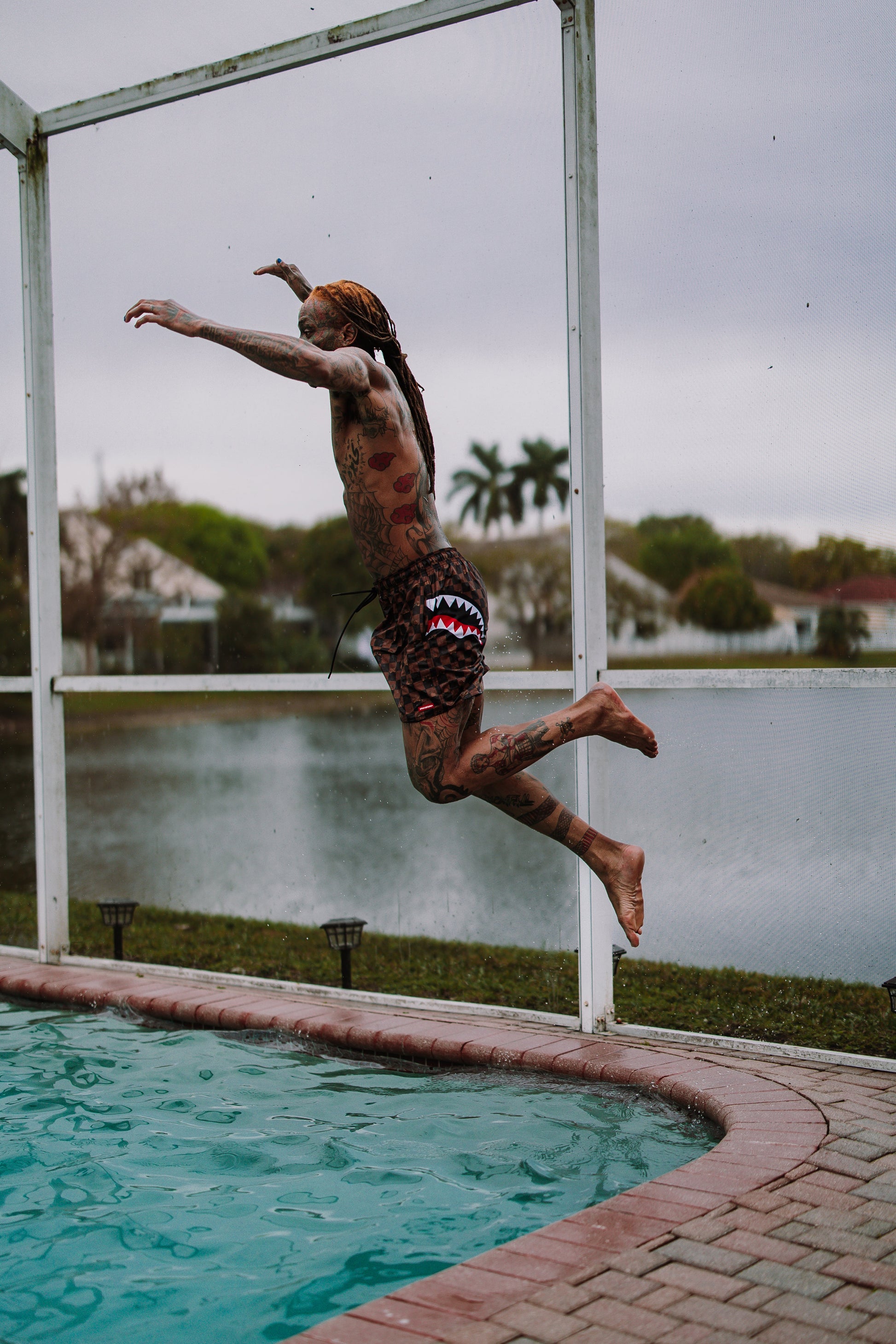 SPRAYGROUND® SWIM PEEKING CHARACTER CHECK SWIM SHORTS